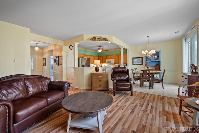 11298 Maplewood Ave, Huntley, IL 60142 - living area featuring ornate columns, a chandelier, a ceiling fan, and light wood-style floors
