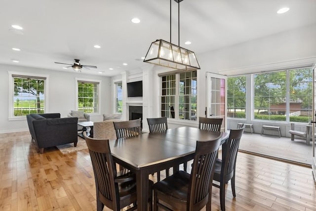 12243 179th St, Mokena, IL 60448 - dining area featuring light wood-style floors, recessed lighting, a ceiling fan, and a fireplace
