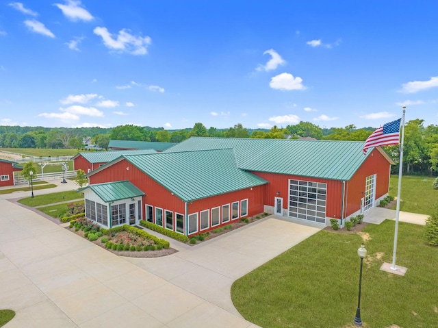12243 179th St, Mokena, IL 60448 - view of front of home with a standing seam roof, concrete driveway, a metal roof, a front yard, and a garage