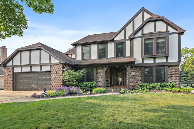 1044 Inverness Ln, Itasca, IL 60143 - tudor-style house with an attached garage, brick siding, a front yard, and stucco siding