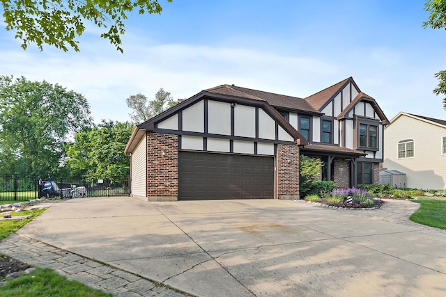 1044 Inverness Ln, Itasca, IL 60143 - english style home featuring a garage, concrete driveway, and brick siding