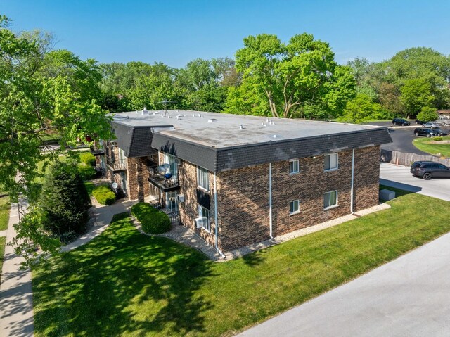 18205 Hart Dr Unit 1A, Homewood, IL 60430 - view of side of home with a lawn and brick siding