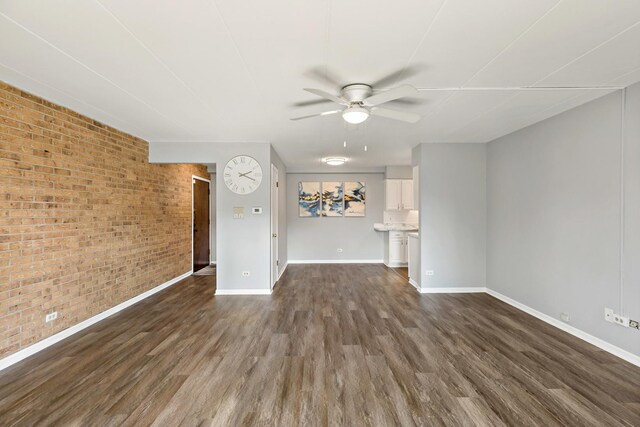 18205 Hart Dr Unit 1A, Homewood, IL 60430 - unfurnished living room featuring ceiling fan, dark wood finished floors, and brick wall