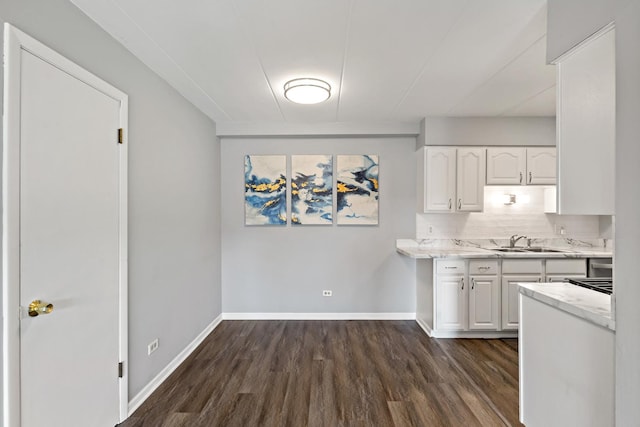 18205 Hart Dr Unit 1A, Homewood, IL 60430 - kitchen featuring dark wood-style flooring, white cabinetry, tasteful backsplash, and light stone counters