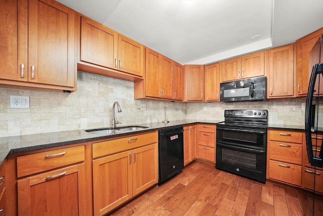 801 S Plymouth Ct Unit 602, Chicago, IL 60605 - kitchen with black appliances, hardwood / wood-style floors, dark stone countertops, and brown cabinetry