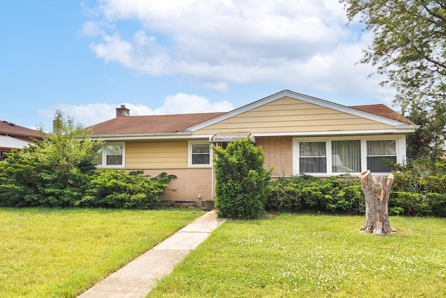 2727 Pauline Ave, Glenview, IL 60025 - view of front of property with brick siding, a front yard, and a chimney