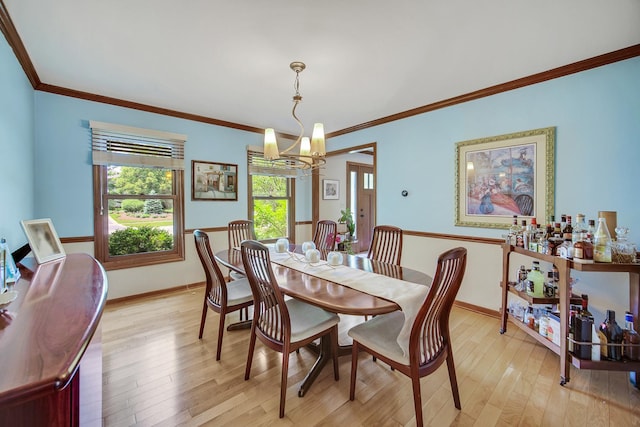 963 Monticello Dr, Naperville, IL 60563 - dining area with a chandelier, light wood-style flooring, and crown molding
