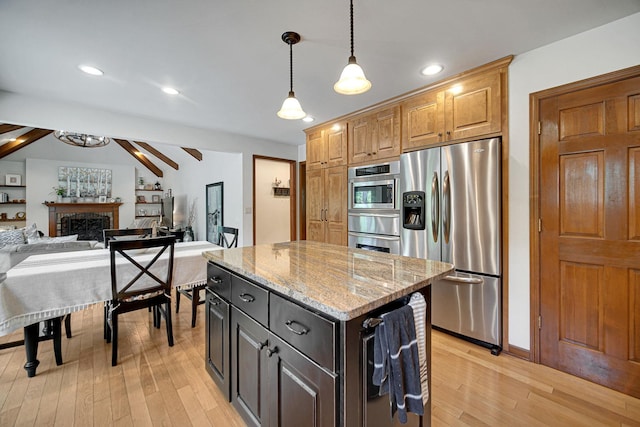 963 Monticello Dr, Naperville, IL 60563 - kitchen with stainless steel refrigerator with ice dispenser, light wood finished floors, a center island, light stone counters, and recessed lighting
