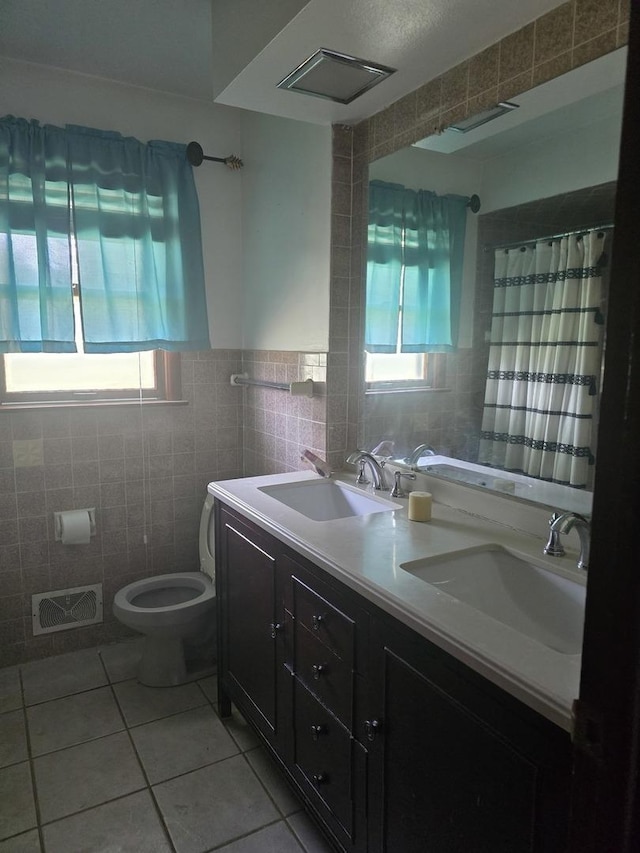 2916 School St, Rockford, IL 61101 - bathroom with tile walls, healthy amount of natural light, tile patterned floors, double vanity, and a shower with shower curtain