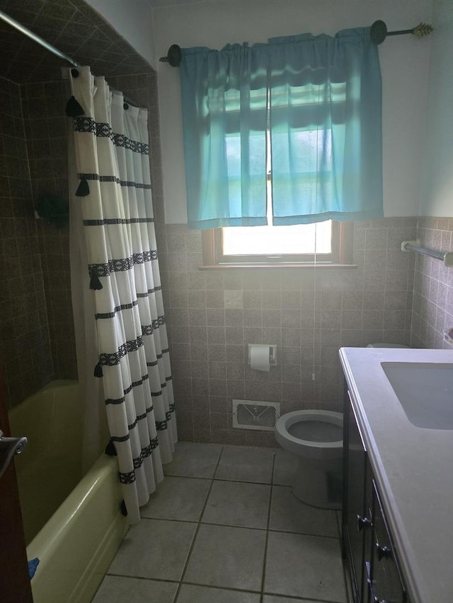 2916 School St, Rockford, IL 61101 - bathroom featuring vanity, tile patterned floors, tile walls, and shower / bathtub combination with curtain