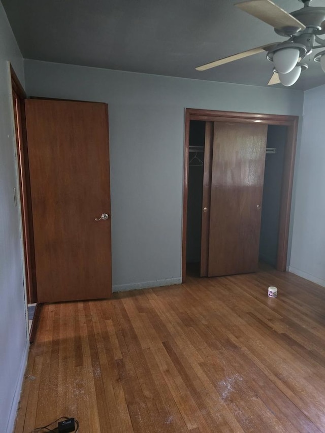 2916 School St, Rockford, IL 61101 - unfurnished bedroom featuring wood-type flooring, a ceiling fan, and a closet