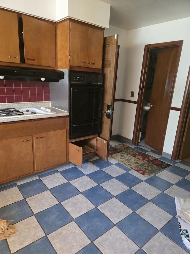2916 School St, Rockford, IL 61101 - kitchen with a warming drawer, oven, extractor fan, brown cabinetry, and tasteful backsplash