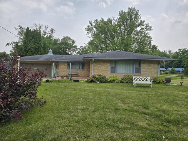 2916 School St, Rockford, IL 61101 - ranch-style home featuring a garage, a front lawn, and brick siding