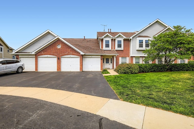 1240 Winfield Ct Unit 4, Roselle, IL 60172 - townhome / multi-family property featuring brick siding, a front yard, a garage, driveway, and roof with shingles