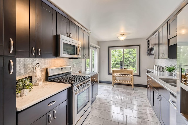 1240 Winfield Ct Unit 4, Roselle, IL 60172 - kitchen featuring stainless steel appliances, tasteful backsplash, light marble finish floors, and light stone counters