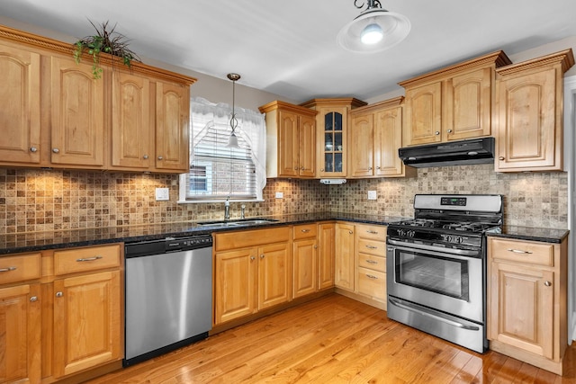 7644 W Norridge St, Norridge, IL 60706 - kitchen with appliances with stainless steel finishes, under cabinet range hood, light wood finished floors, pendant lighting, and glass insert cabinets
