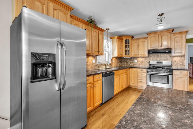 7644 W Norridge St, Norridge, IL 60706 - kitchen featuring stainless steel appliances, under cabinet range hood, glass insert cabinets, light wood finished floors, and decorative backsplash