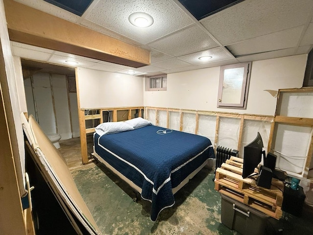 405 N Division Ave, Polo, IL 61064 - bedroom with concrete flooring, radiator, and a paneled ceiling