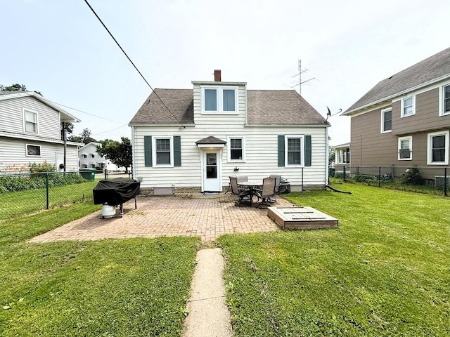 405 N Division Ave, Polo, IL 61064 - rear view of house with a chimney, a patio area, a fenced backyard, and roof with shingles
