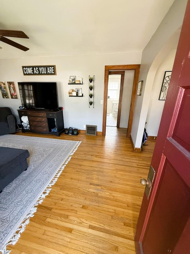 405 N Division Ave, Polo, IL 61064 - living room featuring a ceiling fan, arched walkways, and light wood-style floors