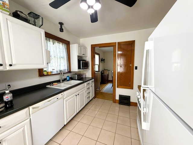 405 N Division Ave, Polo, IL 61064 - kitchen featuring white appliances, ceiling fan, dark countertops, light tile patterned flooring, and white cabinets