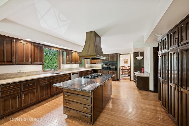 674 Plum Tree Rd, Barrington Hills, IL 60010 - kitchen with gas cooktop, a kitchen island, light wood-style flooring, and dark brown cabinets