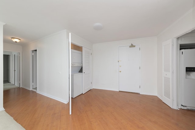940 W Glenlake Ave Unit 24C, Chicago, IL 60660 - spare room with stacked washer / dryer, light wood-style flooring, and crown molding