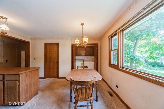 154 N Fremont St, Palatine, IL 60067 - dining area with washer and dryer, a chandelier, and light carpet