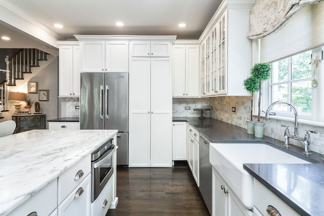 4907 Northcott Ave, Downers Grove, IL 60515 - kitchen featuring appliances with stainless steel finishes, white cabinets, backsplash, dark wood-style floors, and recessed lighting