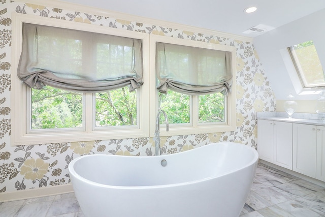 4907 Northcott Ave, Downers Grove, IL 60515 - bathroom featuring wallpapered walls, a freestanding tub, vanity, plenty of natural light, and marble finish floors