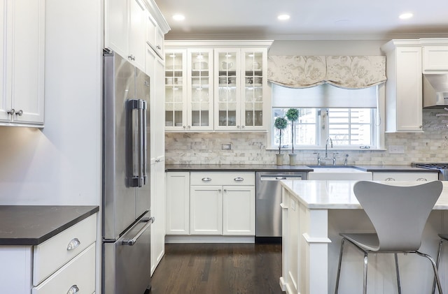 4907 Northcott Ave, Downers Grove, IL 60515 - kitchen featuring stainless steel appliances, white cabinetry, backsplash, glass insert cabinets, and ornamental molding