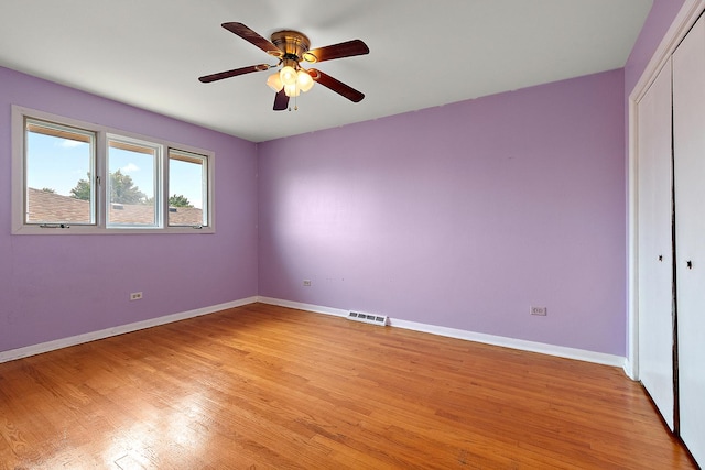 7617 Sycamore Dr, Orland Park, IL 60462 - unfurnished bedroom featuring light wood-style flooring, a closet, and ceiling fan
