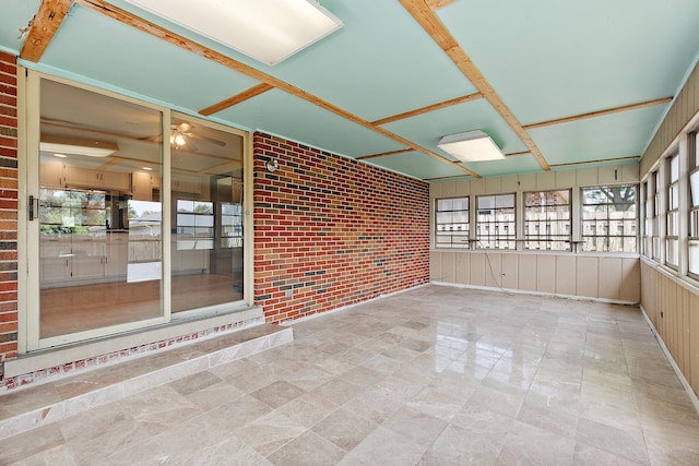7617 Sycamore Dr, Orland Park, IL 60462 - unfurnished sunroom featuring brick wall and a ceiling fan
