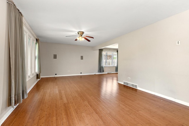 7617 Sycamore Dr, Orland Park, IL 60462 - unfurnished living room featuring a ceiling fan and light wood-style flooring