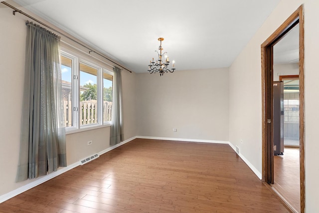 7617 Sycamore Dr, Orland Park, IL 60462 - unfurnished room featuring a chandelier and wood finished floors