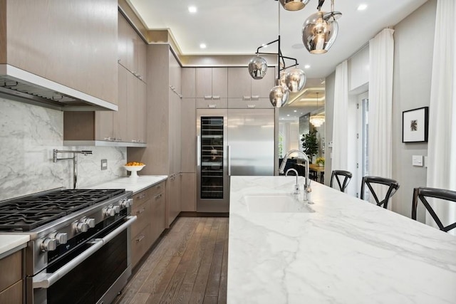 34 E Bellevue Pl, Chicago, IL 60611 - kitchen with stainless steel stove, dark wood-style floors, backsplash, and modern cabinets