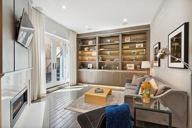 34 E Bellevue Pl, Chicago, IL 60611 - living area with hardwood / wood-style floors, a glass covered fireplace, french doors, built in features, and recessed lighting