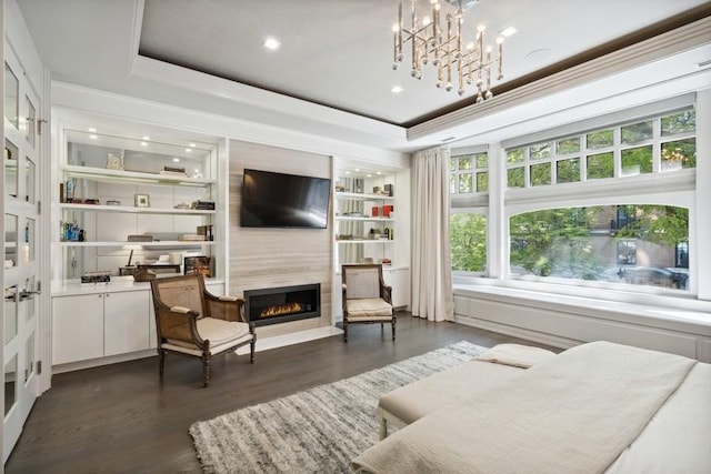 34 E Bellevue Pl, Chicago, IL 60611 - living room with a high end fireplace, dark wood-style floors, crown molding, a tray ceiling, and a chandelier