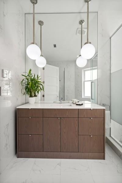 34 E Bellevue Pl, Chicago, IL 60611 - full bathroom featuring vanity, a marble finish shower, and marble finish flooring