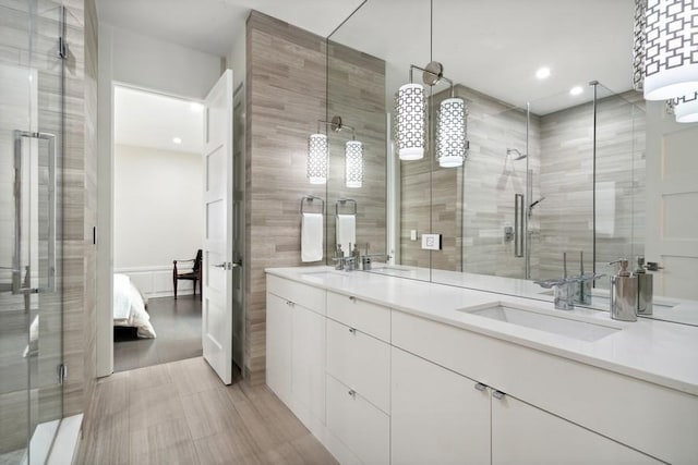 34 E Bellevue Pl, Chicago, IL 60611 - ensuite bathroom featuring tile walls, double vanity, a stall shower, and recessed lighting