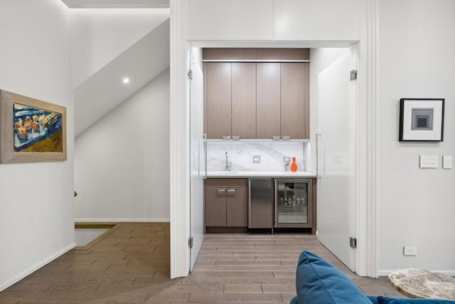 34 E Bellevue Pl, Chicago, IL 60611 - indoor wet bar with beverage cooler, light wood-type flooring, and refrigerator