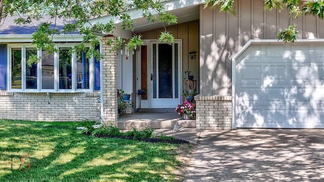 1410 James Ct, Ottawa, IL 61350 - entrance to property with brick siding, driveway, board and batten siding, a garage, and a lawn