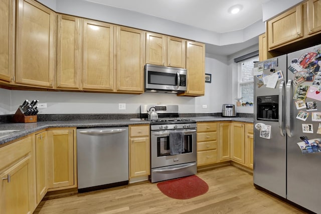 643 W Roscoe St Unit C1, Chicago, IL 60657 - kitchen with appliances with stainless steel finishes, light brown cabinetry, light wood-style flooring, and dark countertops