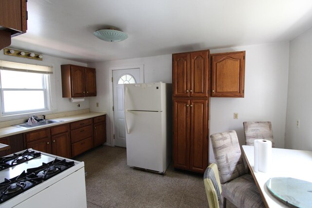 940 S Washington Ave, Kankakee, IL 60901 - kitchen with freestanding refrigerator, stove, healthy amount of natural light, and light countertops