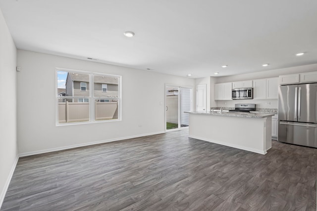 319 Brickyard Ct, Joliet, IL 60436 - kitchen featuring appliances with stainless steel finishes, white cabinets, dark wood-type flooring, recessed lighting, and a center island with sink