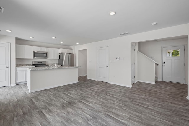 319 Brickyard Ct, Joliet, IL 60436 - kitchen with stainless steel appliances, wood finished floors, white cabinets, a kitchen island with sink, and recessed lighting