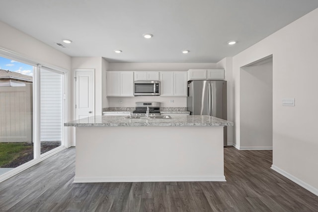 319 Brickyard Ct, Joliet, IL 60436 - kitchen with stainless steel appliances, white cabinetry, dark wood-type flooring, a kitchen island with sink, and recessed lighting