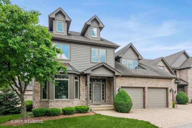 1803 Rizzi Ln, Bartlett, IL 60103 - view of front of property with a garage, decorative driveway, a shingled roof, and brick siding