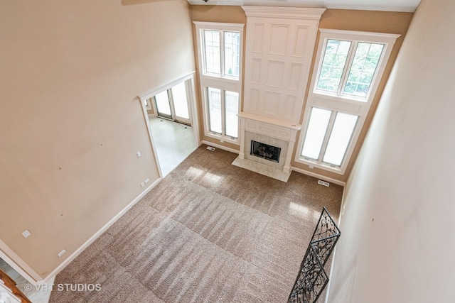 1803 Rizzi Ln, Bartlett, IL 60103 - unfurnished living room with plenty of natural light, a high end fireplace, and carpet flooring