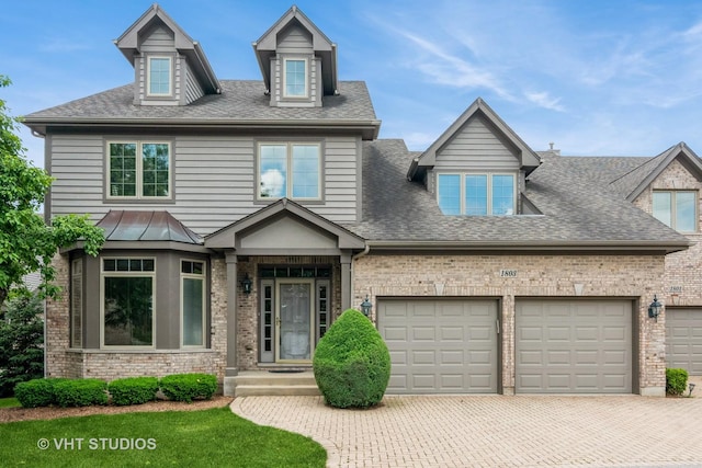 1803 Rizzi Ln, Bartlett, IL 60103 - view of front facade featuring decorative driveway, an attached garage, a shingled roof, and brick siding